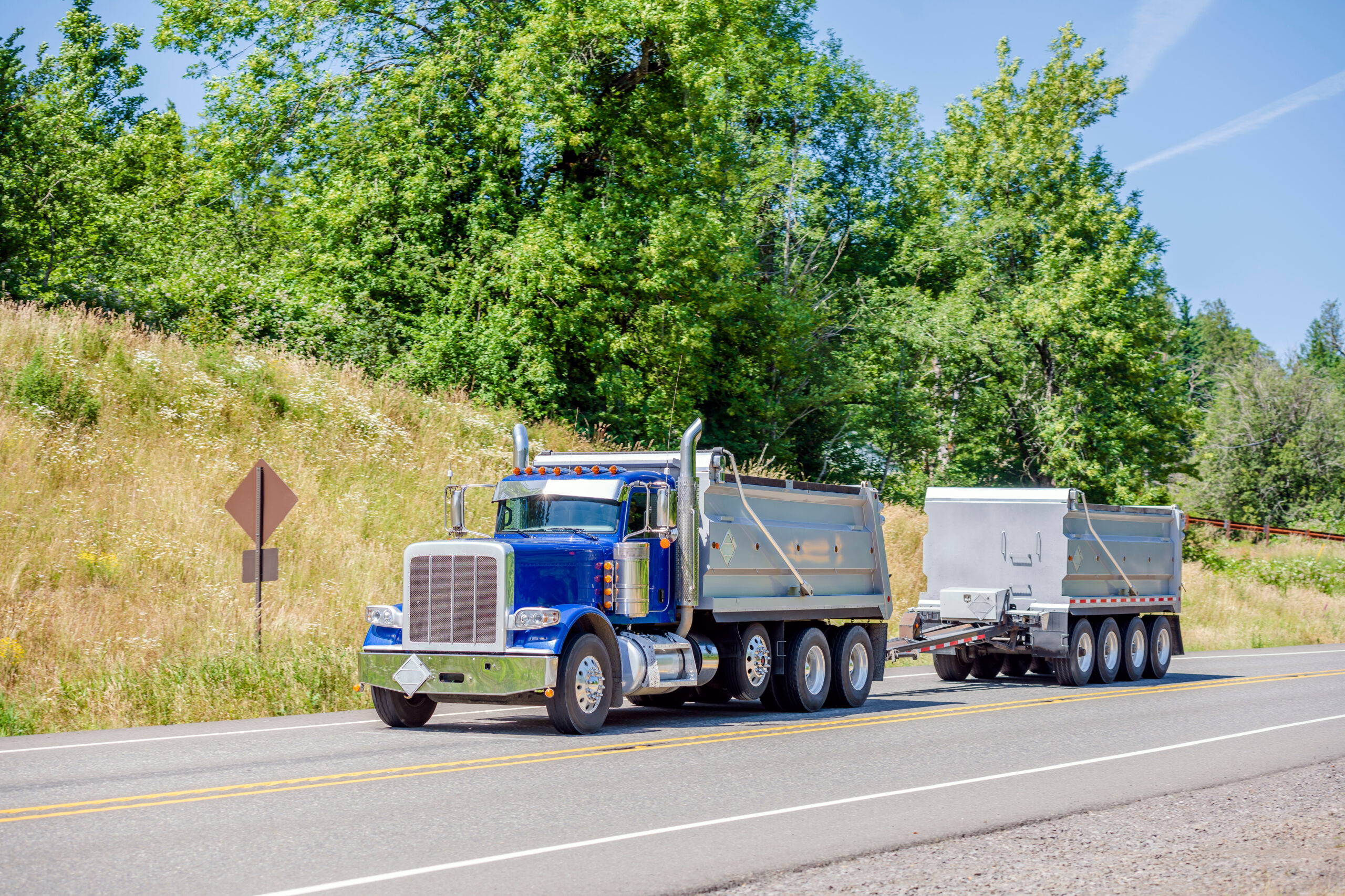 A dump truck delivering construction materials to a job site, showcasing reliable and efficient top construction materials delivery.