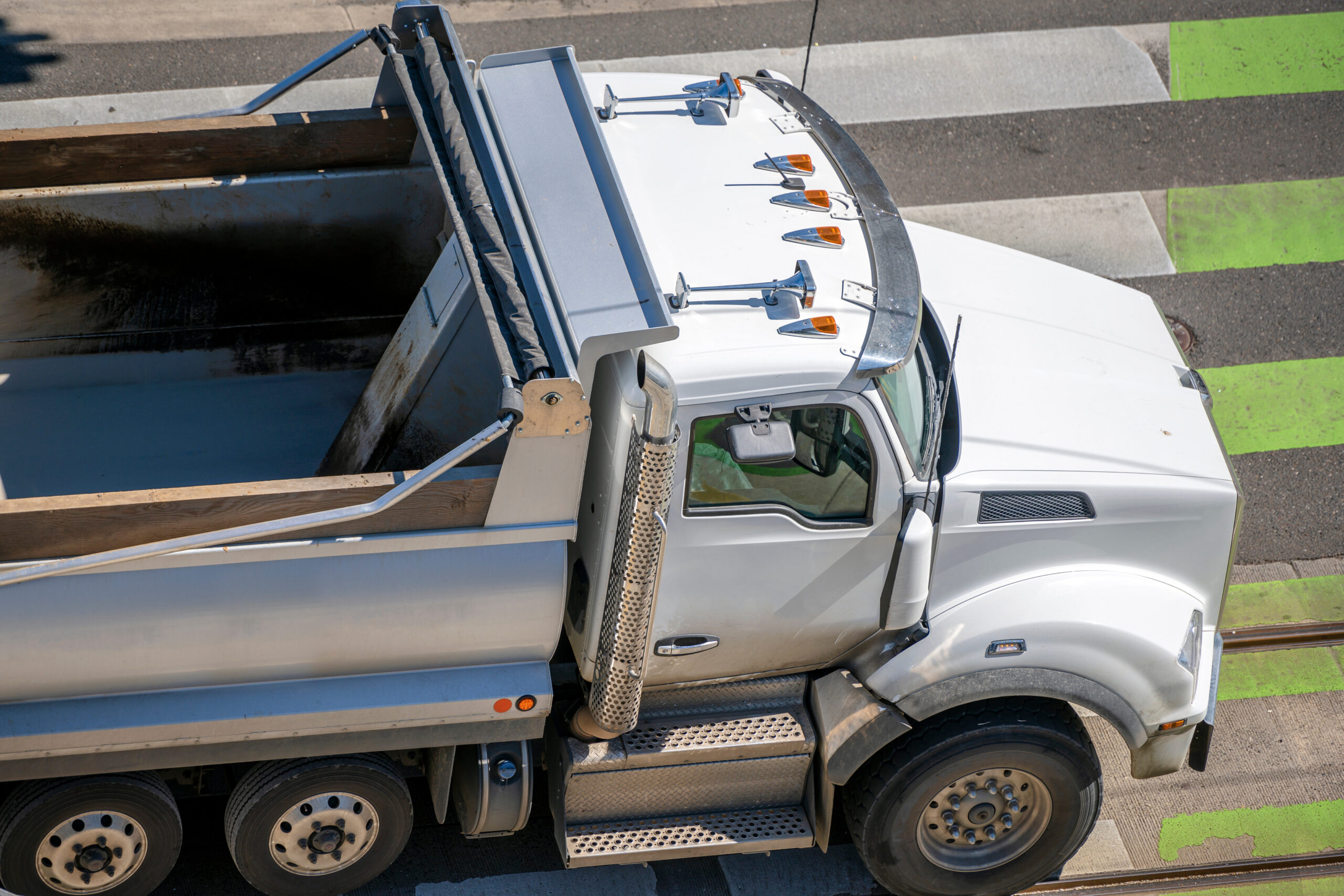 A dump truck delivering high-quality construction materials to a job site, symbolizing reliable transportation and sourcing in the Construction Industry Outlook 2025.