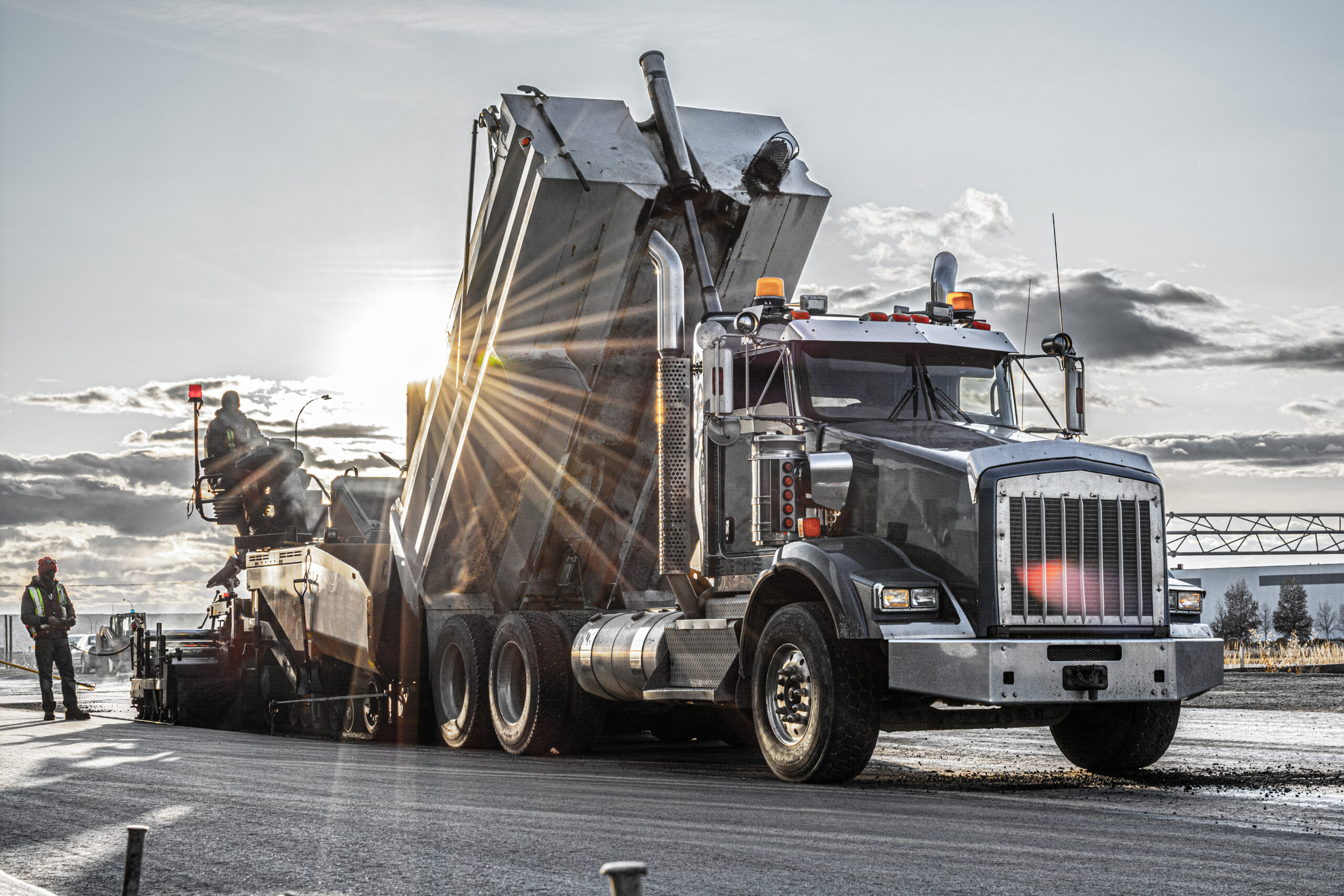 A dump truck in action, delivering construction materials like sand and gravel, showcasing reliable dump truck services in California